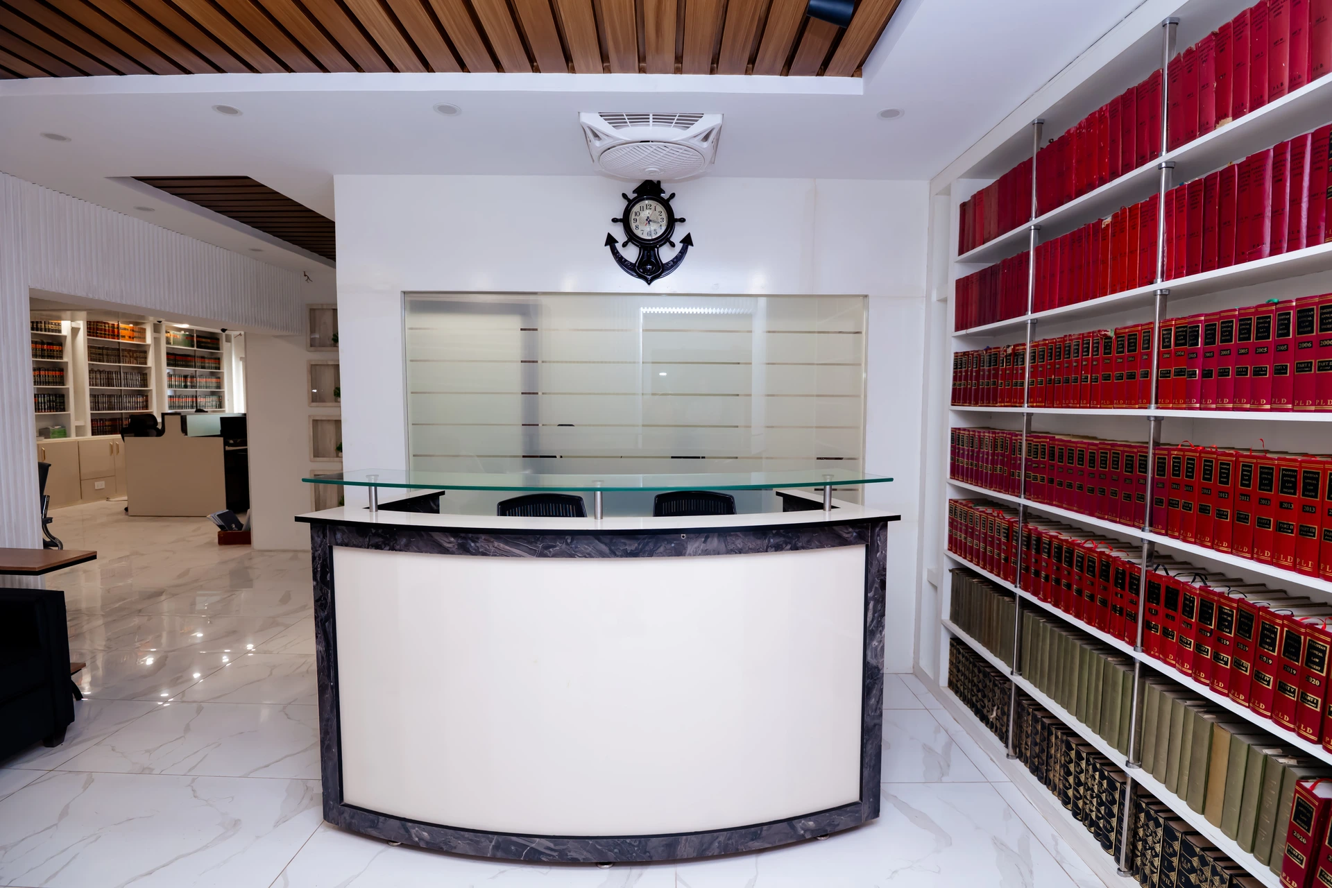 Kolachi & Co. Law Firm Reception Desk with Red Legal Books